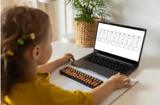 Child learning Abacus online with expert guidance, improving mental math skills and accuracy in calculations.